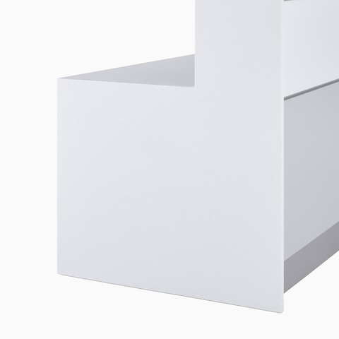 A close-up view of the white Corian full end panel with white laminate tops and white and gray fronts on a forty two inch high prefab Commend Nurses Station.