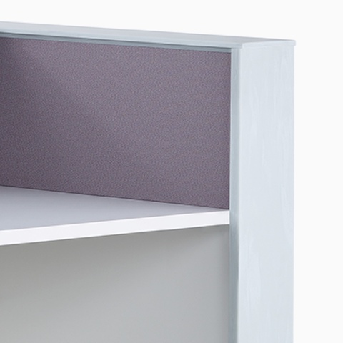 A close-up view of the purple tackable fabric panel on a prefab Commend Nurses Station.