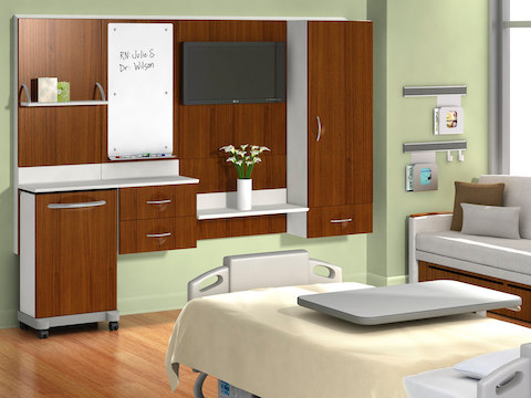 Compass System modular healthcare components in a patient room with a bed and sleeper sofa. 