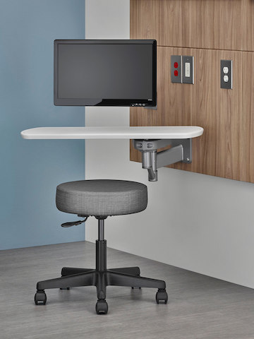 An adjustable computer monitor and small table attached to a Compass System tile. An adjustable computer monitor and small table attached to a Compass System tile.