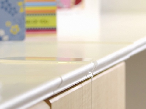 Close view of how the Compass System's edge design prevents spills from seeping into drawers and cabinets. 