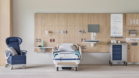 Compass System headwall in a patient room with a blue Ava Recliner with a Procedure and Supply Cart with MBrace technology support.