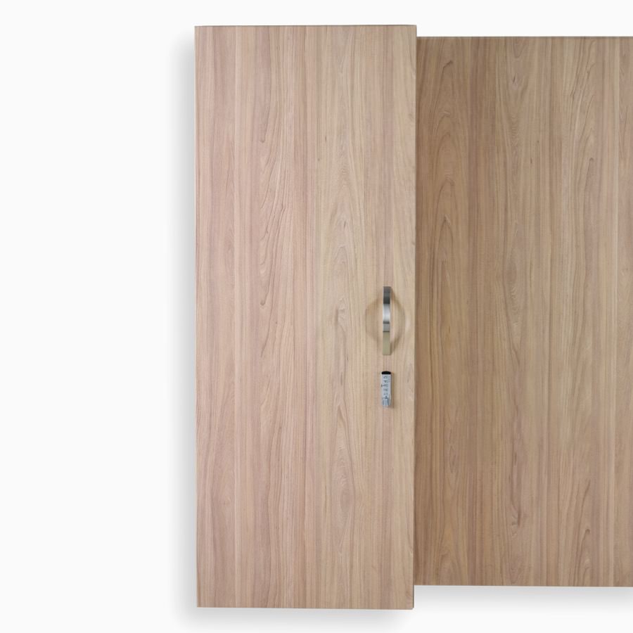 Detail of Compass System wardrobe cabinet in a medium wood finish with keyless lock.