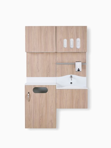 Compass system casework wall unit in medium wood laminate finish with integrated waste receptacle, white solid surface sink, and upper storage for gloves.