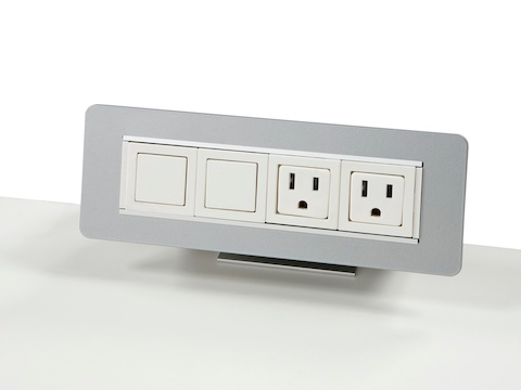 A surface-attached Connect power port with two power outlets and two blank outlets.