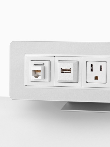 Partial view of a surface-attached Connect Power and Data distributor, showing three connection points. Partial view of a surface-attached Connect Power and Data distributor, showing three connection points.