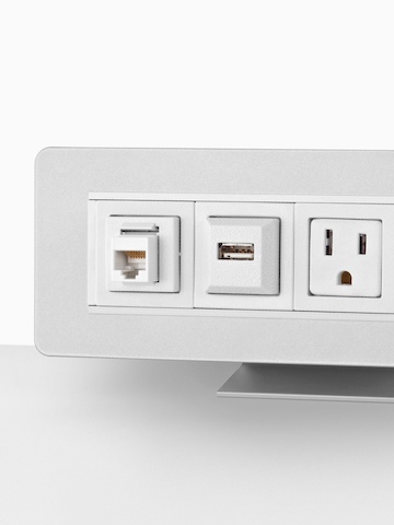 Partial view of a surface-attached Connect Power and Data distributor, showing three connection points.