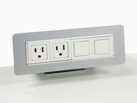 Partial view of a Connect Power and Data distributor, showing two power outlets and one blank outlet. Partial view of a Connect Power and Data distributor, showing two power outlets and one blank outlet.