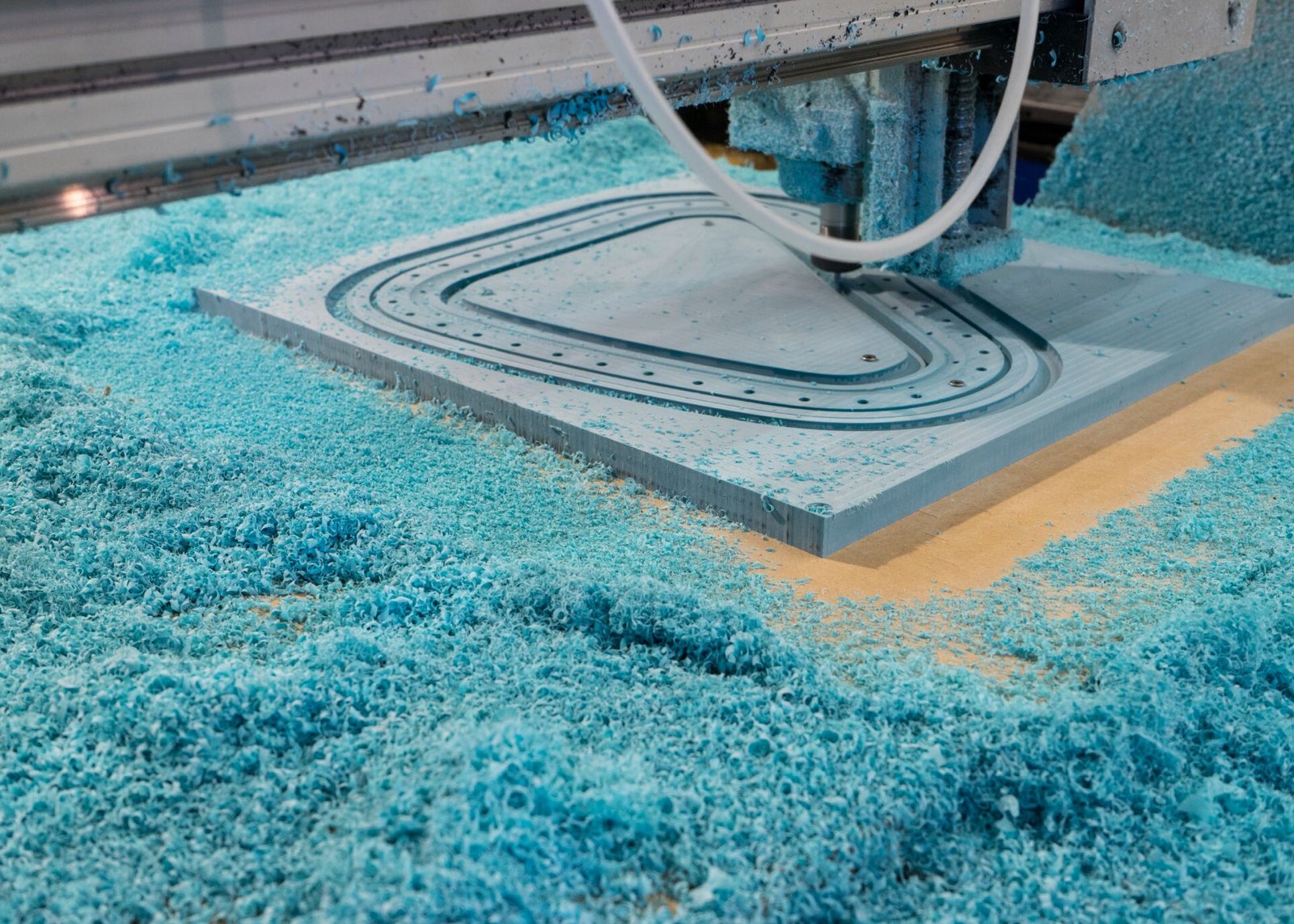 A CNC machine cuts out a component for a prototype of the Cosm Chair.