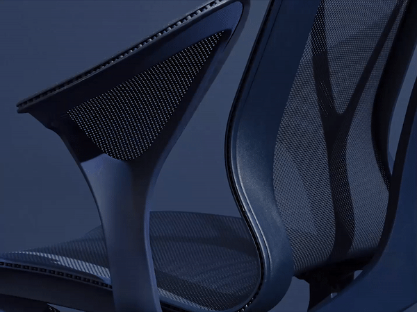 A Nightfall dark blue Cosm Chair with Leaf Arms features an animation that highlights how the chair's suspension creates seamless support. 
