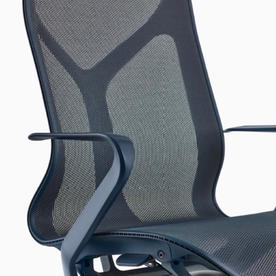 A high-back Cosm Chair with fixed arms and Nightfall dark blue frame and suspension material.