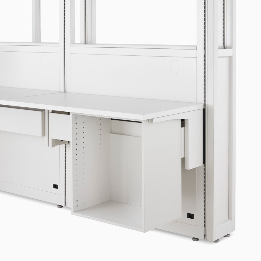 Detail of soft white Co/Struc System frame module, work surface, and open storage unit hanging on an adapter rail under the surface.