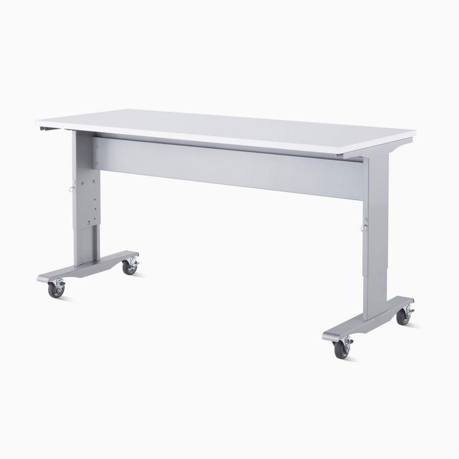 Detail of a Co/Struc System mobile and height-adjustable work process table with a silver frame and white top surface.