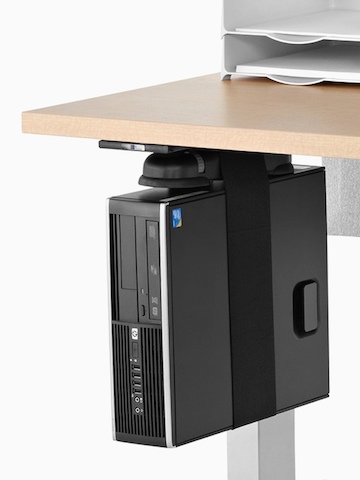 A black CPU secured by a nylon strap and attached to the underside of a woodgrain work surface with a Loop CPU Support. A black CPU secured by a nylon strap and attached to the underside of a woodgrain work surface with a Loop CPU Support.