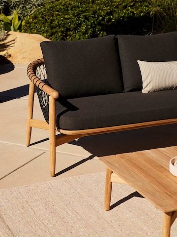 Crosshatch Outdoor Settee and Coffee Table in an environmental setting.