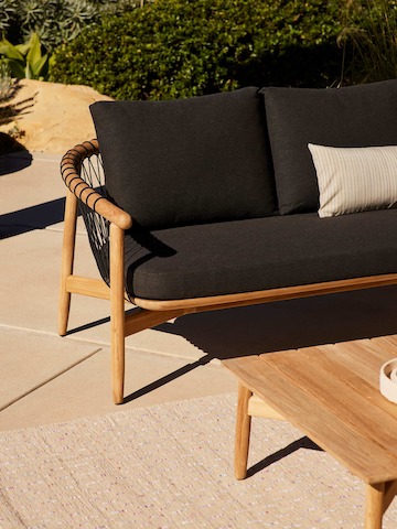 Crosshatch Outdoor Settee and Coffee Table in an environmental setting.