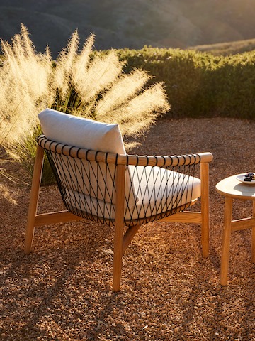 Crosshatch Outdoor Lounge Chair and Trilobe Side Table in an environmental setting.