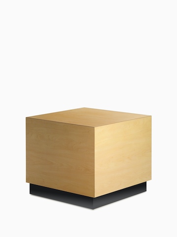 Cube Table in a honey maple finish and a black plinth base, viewed at an angle.