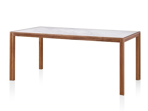 A walnut Doubleframe Table featuring a Carrara mable top, viewed from an angle.