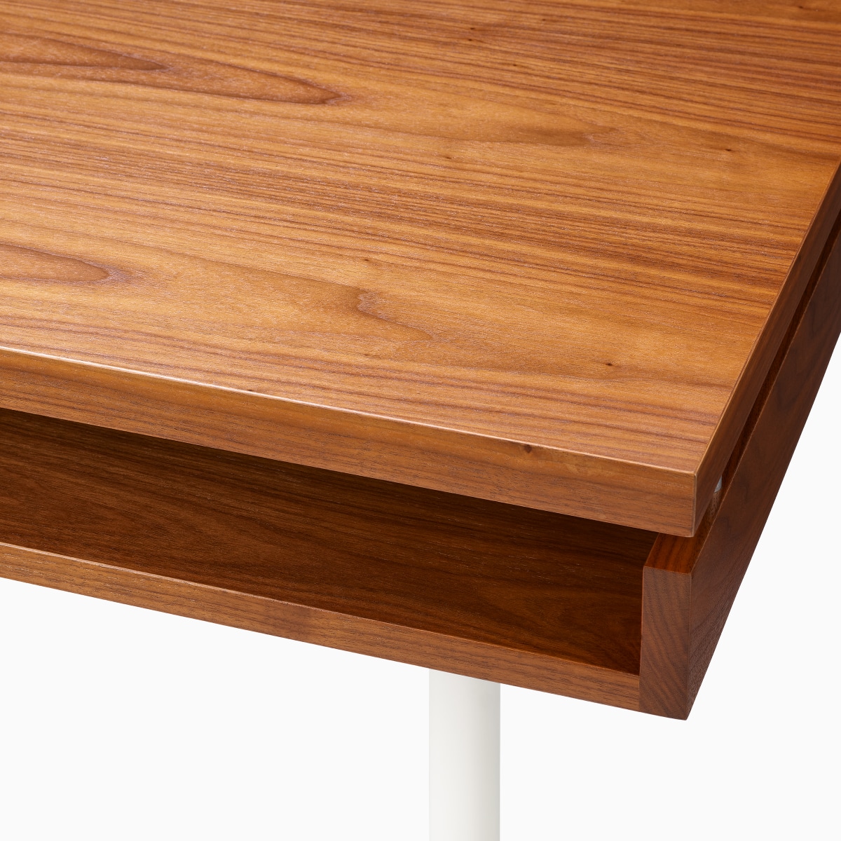 Detail of the secondary storage shelf of the Eames 2500 Series Executive Desk in walnut