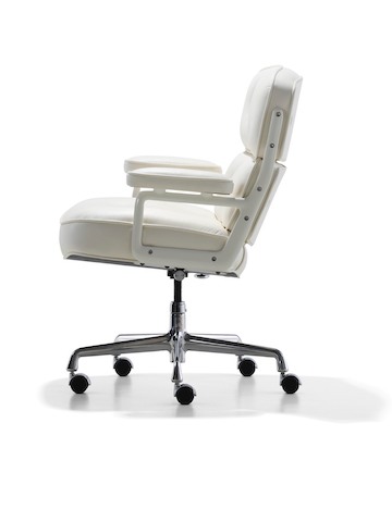 Profile view of a white leather Eames Executive Chair.