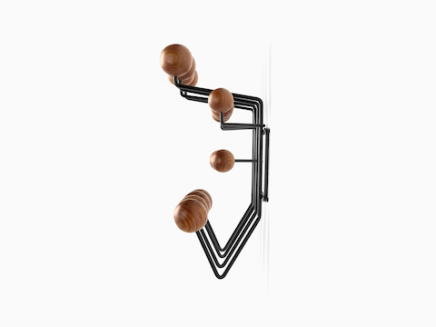 An Eames Hang-It-All storage rack, featuring a white wire frame and multicolored wood knobs.