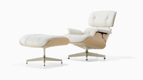 White leather Eames Lounge Chair and Ottoman with a white ash veneer shell, viewed from a 45-degree angle. 