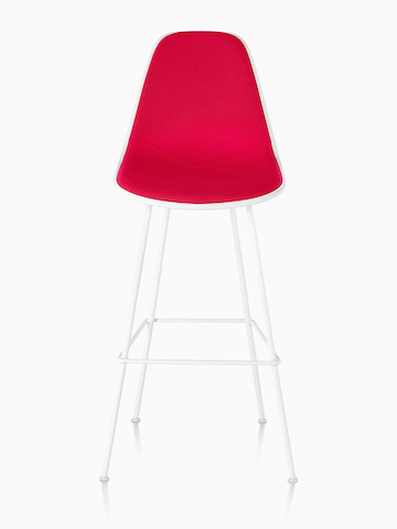 White Eames Molded Plastic Stool with red upholstery, viewed from the front. White Eames Molded Plastic Stool with red upholstery, viewed from the front.