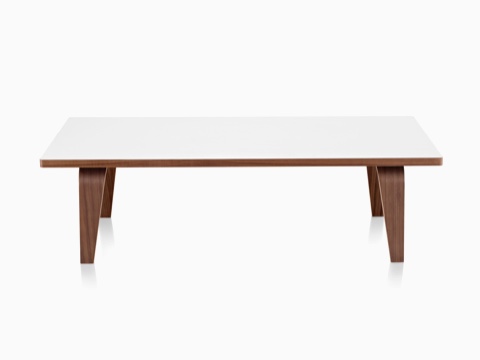 An Eames Rectangular Coffee Table with a white top and molded plywood legs in a medium finish. 