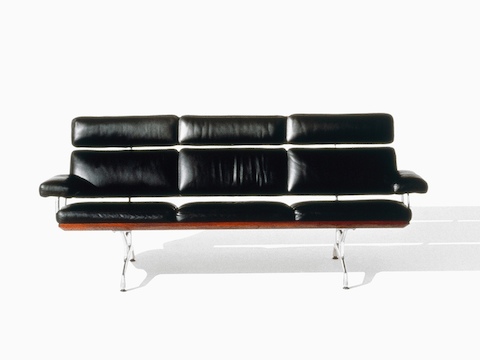 Black leather Eames Sofa, viewed from the front. 