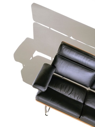 Overhead view of a partial black leather Eames Sofa. 