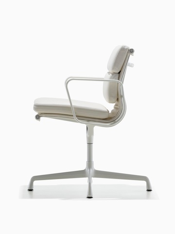 Profile view of a white leather Eames Soft Pad Chair.