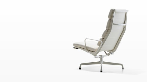 Three-quarter rear view of a white Eames Soft Pad lounge chair.