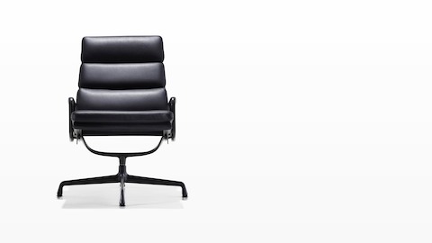 Black leather Eames Soft Pad lounge chair with a black frame and base, viewed from the front. Black leather Eames Soft Pad lounge chair with a black frame and base, viewed from the front.