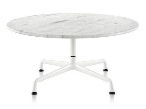 A round Eames outdoor table with a white marble top and white base. 