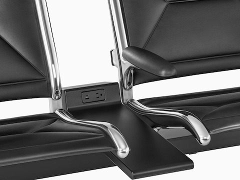 Connected black sling seating with integrated power source that includes USB-C port, USB-A port, and A/C power outlet.