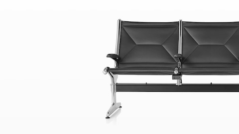 Three connected black sling seating with integrated power source that includes USB-C port, USB-A port, and A/C power outlet. Three connected black sling seating with integrated power source that includes USB-C port, USB-A port, and A/C power outlet.