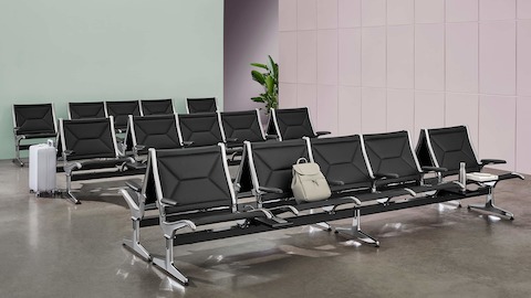 Multiple rows of Eames Tandem Sling Seating in a public waiting area.