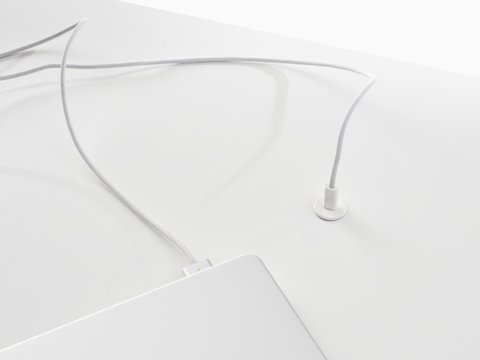 Surface-integrated single port USB-C power solution shown in white charging a laptop.