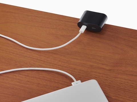 Surface-mounted Ello Mini USB-C power access charging a laptop.
