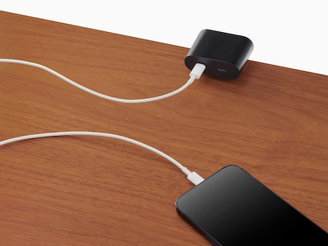 Surface-mounted Ello Mini USB-C power access charging a phone.
