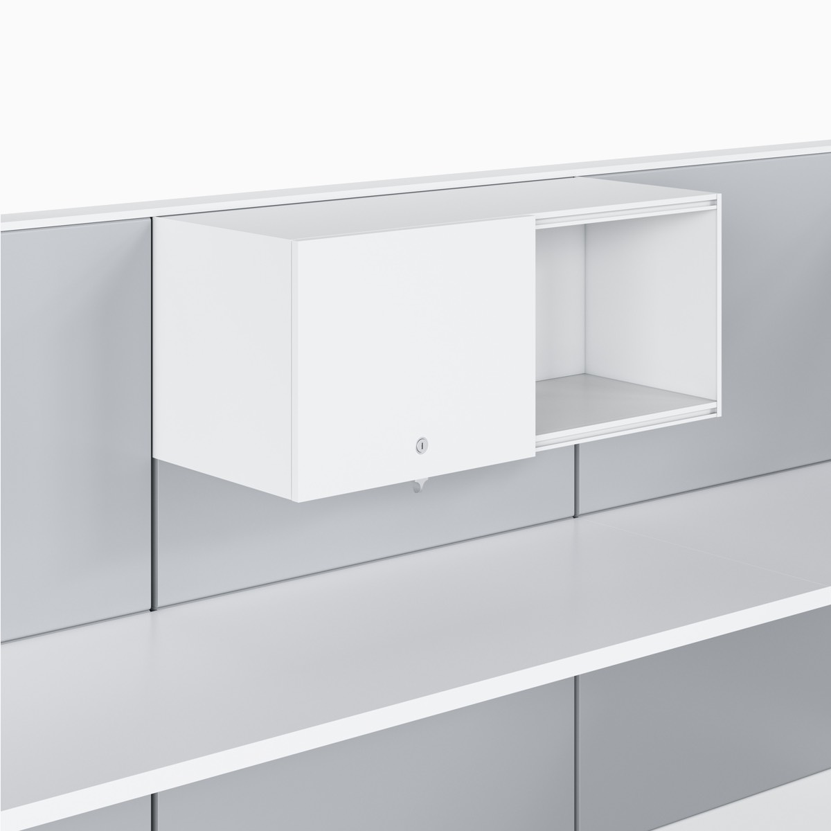 Ethospace wall unit in white trim and light gray tiles with an upper storage unit with a sliding door in a white finish hung above a white solid surface work surface.