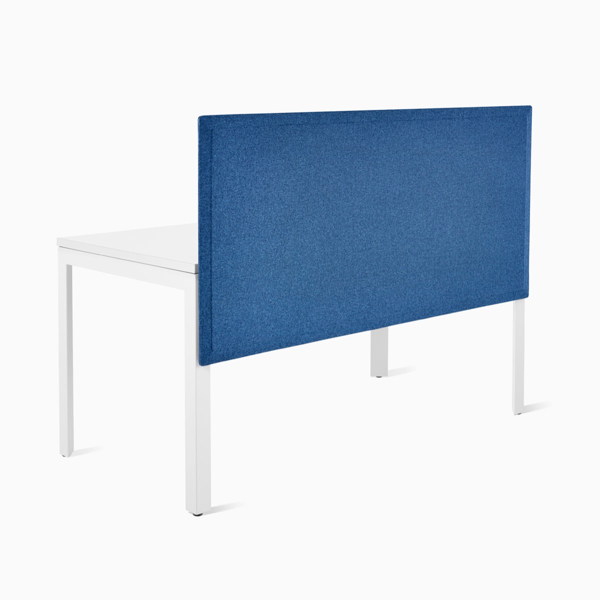 A blue fabric Pari privacy screen attached to a white Layout Studio table.