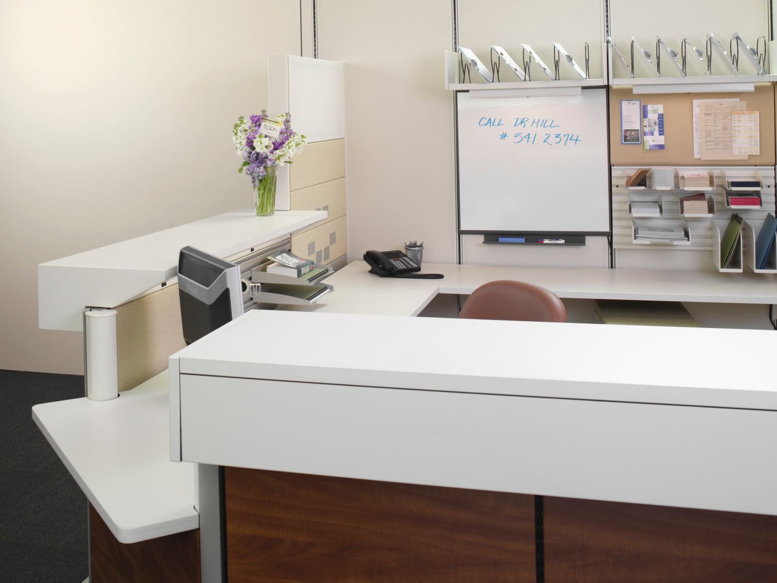 An Ethospace Nurses Station with work surfaces, transaction surfaces, tackable tiles, and accessories. An Ethospace Nurses Station with work surfaces, transaction surfaces, tackable tiles, and accessories.