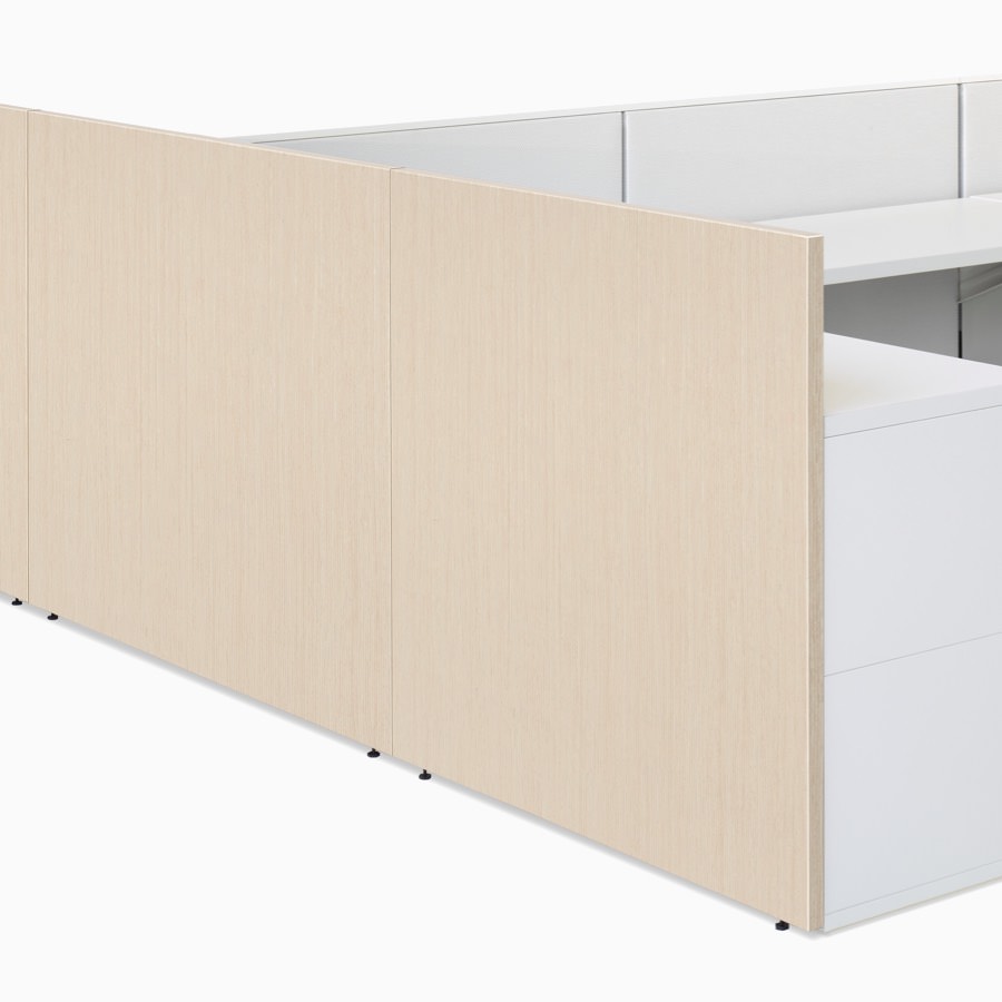 A detail of an Ethospace panel in an ash wood finish and attached to a workstation in a white finish.