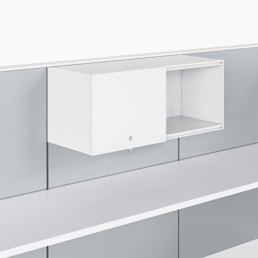 Ethospace wall unit in white trim and light gray tiles, with upper storage and a sliding door hung above a white work surface.