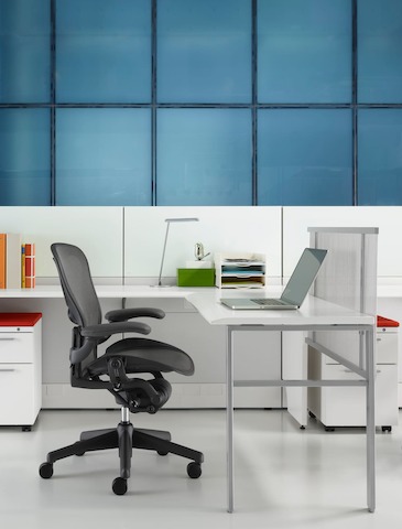 Espaço de trabalho Ethospace com painéis de divisão baixa e cadeira de escritório ergonómica preta Aeron.