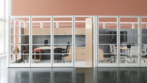 A conference room next to a private office, both made of Ethospace panels and storage systems.