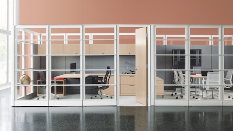 Private office created from Ethospace System panels with Black Embody ergonomic desk chair next to a private conference room with Setu office chairs. Private office created from Ethospace System panels with Black Embody ergonomic desk chair next to a private conference room with Setu office chairs.