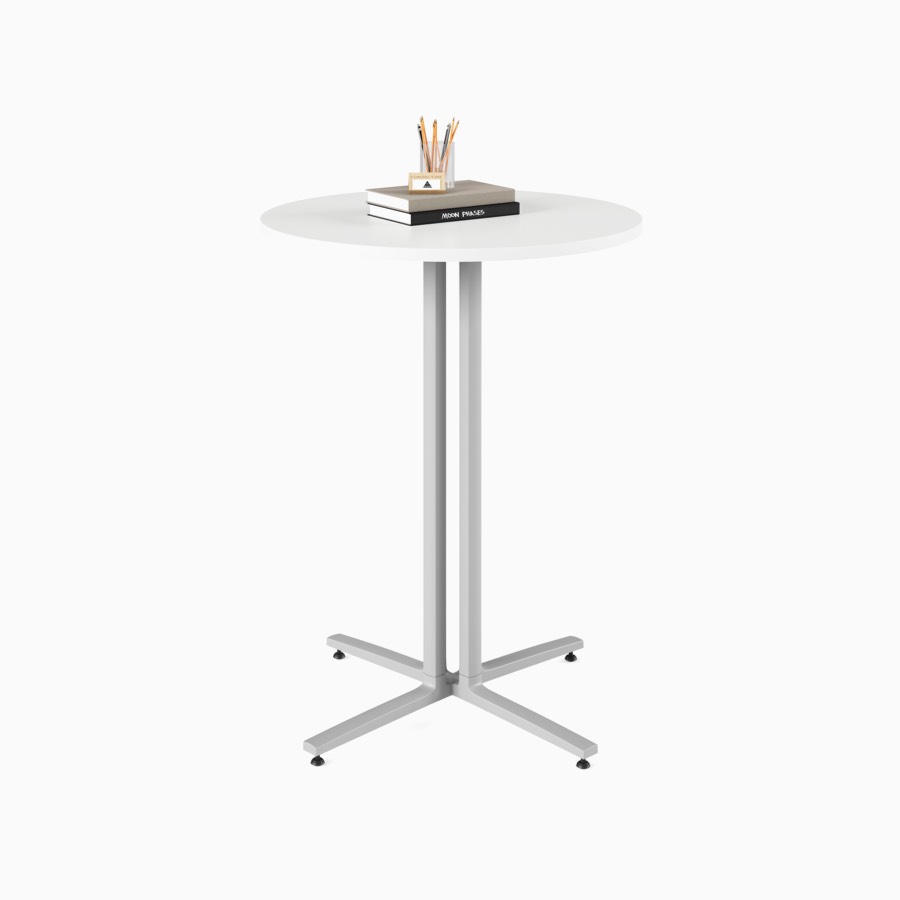 A white, round, standing height Everywhere Table with grey legs.